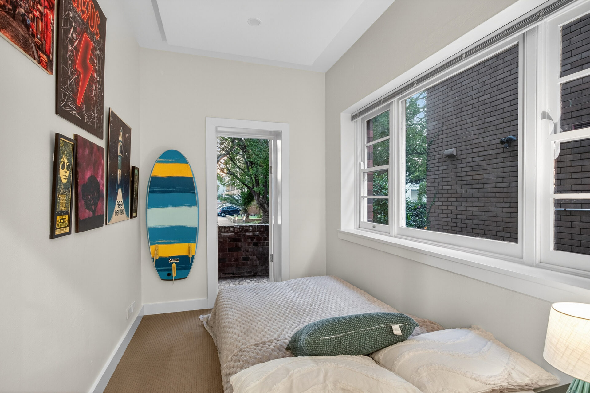 Sunroom with surfboard and music posters